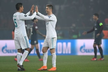 Real Madrid's Portuguese forward Cristiano Ronaldo celebrates with French defender Raphael Varane after win over PSG.