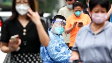 BEIJING, CHINA - JUNE 14: A guard wears protective clothing as he looks on at a COVID-19 test site on June 14, 2022 in Beijing, China. China is trying to contain a spike in coronavirus cases in the capital Beijing, Local authorities have initiated mass testing in most districts, placing some neighborhoods under lockdown where cases are found in an effort to prevent the spread of COVID-19. (Photo by Lintao Zhang/Getty Images)