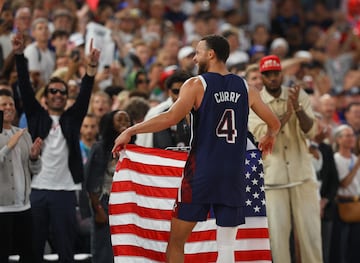 Stephen Curry of United States celebrates with flag after United States win gold.