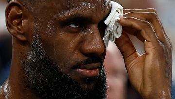 USA's #06 LeBron James applies a compress after he was involuntarily hit in the face during a rebound, in the men's quarterfinal basketball match between Brazil and the USA during the Paris 2024 Olympic Games at the Bercy Arena in Paris on August 6, 2024. (Photo by Luis TATO / AFP)