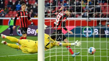 Leverkusen's Italian forward Lucas Alario and Bielefeld's German goalkeeper Stefan Ortega Moreno vie for the ball during the German first division Bundesliga football match between Bayer Leverkusen and Arminia Bielefeld in Leverkusen, western Germany on February 26, 2022. (Photo by Ina FASSBENDER / AFP) / DFL REGULATIONS PROHIBIT ANY USE OF PHOTOGRAPHS AS IMAGE SEQUENCES AND/OR QUASI-VIDEO