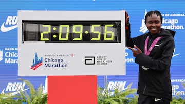 (FILES) Ruth Chepngetich of Kenya poses with a clock after winning the 2024 Chicago Marathon professional women's division and setting a new world record with a time of 2:09:56 at Grant Park in Chicago, Illinois on October 13, 2024. Marathon world record holder Ruth Chepngetich gets three-year doping ban on October 23, 2025. (Photo by Michael Reaves / GETTY IMAGES NORTH AMERICA / AFP)