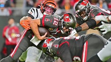 TAMPA, FLORIDA - DECEMBER 18: Logan Wilson #55 of the Cincinnati Bengals forces a fumble by Tom Brady #12 of the Tampa Bay Buccaneers during the third quarter at Raymond James Stadium on December 18, 2022 in Tampa, Florida. (Photo by Julio Aguilar/Getty Images)