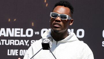 Undisputed junior middleweight world champion Jermell Charlo, right, speaks as undisputed super middleweight world champion Canelo Álvarez, left, of Mexico, shields his eyes during a boxing news conference, Wednesday, Aug. 16, 2023, in Beverly Hills, Calif. (AP Photo/Damian Dovarganes)