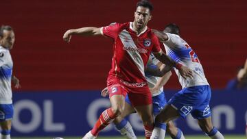 Gabriel Ávalos Stumpfs of Argentina's Argentinos Juniors, left, and Juan Leiva of Chile's Universidad Catolica battle for the ball during a Copa Libertadores soccer match in Buenos Aires, Argentina, Wednesday, May 12, 2021. (Juan Ignacio