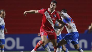 Gabriel &Aacute;valos Stumpfs of Argentina&#039;s Argentinos Juniors, left, and Juan Leiva of Chile&#039;s Universidad Catolica battle for the ball during a Copa Libertadores soccer match in Buenos Aires, Argentina, Wednesday, May 12, 2021. (Juan Ignacio 