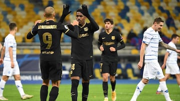 Barcelona's Danish forward Martin Braithwaite (L) celebrates with Barcelona's Spanish defender Junior Firpo after scoring a goal during the UEFA Champions League group G football match between Dynamo Kiev and Barcelona at the Olympiyskiy stadium
