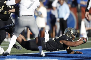 BIRMINGHAM, AL - DECEMBER 22: Jamie Newman #12 of the Wake Forest Demon Deacons dives into the end zone for the winning touchdown against the Memphis Tigers in the fourth quarter of the Birmingham Bowl at Legion Field on December 22, 2018 in Birmingham, Alabama.