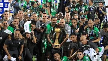 Nacional players celebrate with the trophy after winning the Colombian League second leg football final match between Atletico Nacional and Deportes Tolima at the Atanasio Girardot Stadium in Medellin, Colombia on December 22, 2024. (Photo by JAIME SALDARRIAGA / AFP)