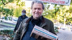 Steve Bannon, former advisor to President Donald Trump, brandishes a Financial Times headline about Liz Truss, upon arriving for sentencing.