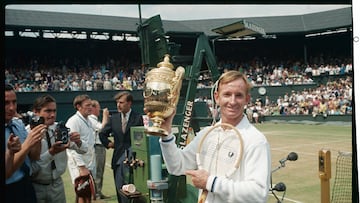 Rod Laver flashes a winning smile as he holds the loving cup high after defeating fellow Australian Tony Roche 6-3, 6-4, 6-2