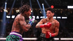 LAS VEGAS, NEVADA - APRIL 22: Ryan Garcia in the black trunks exchanges punches with Gervonta Davis in the green and purple trunks during their catchweight bout at T-Mobile Arena on April 22, 2023 in Las Vegas, Nevada.   Al Bello/Getty Images/AFP (Photo by AL BELLO / GETTY IMAGES NORTH AMERICA / Getty Images via AFP)