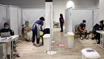 People wait to get the coronavirus vaccine, at a vaccination centre in Westfield Stratford City shopping centre, amid the outbreak of coronavirus disease (COVID-19), in London, Britain, February 18, 2021. REUTERS/Henry Nicholls