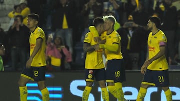 America's Uruguayan midfielder #07 Brian Rodriguez celebrates with teammates defender #18 Cristian Calderon and forward #21 Henry Martin after scoring his team's first goal fight for the ball during the Liga MX Apertura tournament football match between America and Monterrey at the Ciudad de los Deportes stadium in Mexico City on October 27, 2024. (Photo by Victor Cruz / AFP)