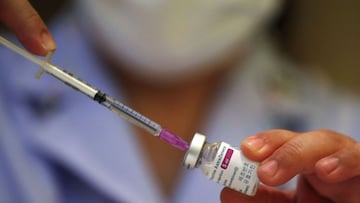 A Thai nurse prepares a syringe drawing from a vial of vaccine against covid-19 developed by AstraZeneca. 