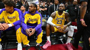 CLEVELAND, OHIO - OCTOBER 30: Bronny James #9 sits with LeBron James #23 of the Los Angeles Lakers on the bench during the first half against the Cleveland Cavaliers at Rocket Mortgage Fieldhouse on October 30, 2024 in Cleveland, Ohio. NOTE TO USER: User expressly acknowledges and agrees that, by downloading and or using this photograph, User is consenting to the terms and conditions of the Getty Images License Agreement. Jason Miller/Getty Images/AFP (Photo by Jason Miller / GETTY IMAGES NORTH AMERICA / Getty Images via AFP)