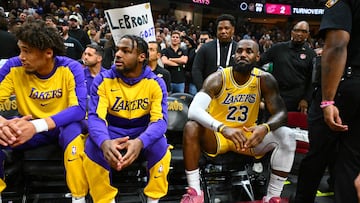 CLEVELAND, OHIO - OCTOBER 30: Bronny James #9 sits with LeBron James #23 of the Los Angeles Lakers on the bench during the first half against the Cleveland Cavaliers at Rocket Mortgage Fieldhouse on October 30, 2024 in Cleveland, Ohio. NOTE TO USER: User expressly acknowledges and agrees that, by downloading and or using this photograph, User is consenting to the terms and conditions of the Getty Images License Agreement. Jason Miller/Getty Images/AFP (Photo by Jason Miller / GETTY IMAGES NORTH AMERICA / Getty Images via AFP)