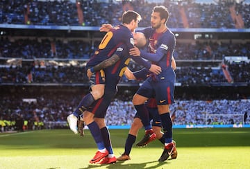 Aleix Vidal celebrates with teammates Lionel Messi and Andre Gomes after scoring his side's third goal.