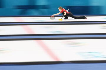 Kaitlyn Lawes and John Morris compete during the Curling Mixed Doubles