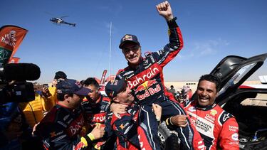 First-placed for the auto category JCW X-RAID Team Spain's driver Carlos Sainz (C), celebrates as he is congratulated by second-placed Toyota's team Qatar's driver Nasser Al-Attiyah (R) and by third-placed JCW X-RAID Team France's Stephane Peterhansel on