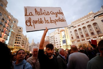 A man holds a placard as civil groups and unions protest against the management of the emergency response to the deadly floods in eastern Spain, in Valencia, Spain, November 9, 2024. REUTERS/Eva Manez