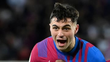 Barcelona's Spanish midfielder Pedri celebrates scoring the opening goal with Barcelona's French forward Ousmane Dembele (R) during the Spanish League football match between FC Barcelona and Sevilla FC at the Camp Nou stadium in Barcelona on Apr