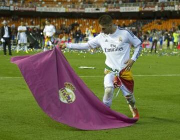 La temporada pasada la 2013-14 el Real Madrid ganaría la Copa del Rey, de nuevo ante el Barcelona en Mestalla. Aquí el defensa sevillano celebra el triunfo con un capote con el escudo blanco.