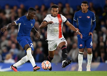 Moises Caicedo and Luton Town's Jacob Brown battle for the ball