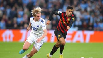 COPENHAGEN, DENMARK - OCTOBER 11: Joao Cancelo of Manchester City beats Hakon Arnar Haraldsson of FC Copenhagen during the UEFA Champions League group G match between FC Copenhagen and Manchester City at Parken Stadium on October 11, 2022 in Copenhagen, Denmark. (Photo by James Gill - Danehouse/Getty Images)