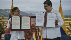 Gustavo Petro, Colombia's president, left, and Nicolas Maduro, Venezuela's president, display signed memorandums during a meeting at the Tienditas International Bridge in Cucuta, Colombia, on Thursday, Feb. 16, 2023. During the meeting near the border, the heads of state signed a memorandum of understanding focused on modernizing trade rules between Colombia and Venezuela. Photographer: Ferley Ospina/Bloomberg via Getty Images