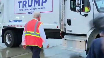 Donald Trump close to a fall before climbing into garbage truck to face reporters