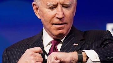 U.S. President-elect Joe Biden looks at his watch as he arrives arrives to announce former South Bend, Indiana Mayor Pete Buttigieg as his nominee for secretary of transportation during a news conference at Biden&#039;s transition headquarters in Wilmingt