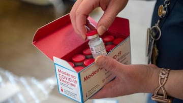 RN Courtney Senechal unpacks a special refrigerated box of Moderna Covid-19 vaccines as she prepared to ready more supply for use at the East Boston Neighborhood Health Center (EBNHC) in Boston, Massachusetts on December 24, 2020. - EBNHC recently received 1400 doses of Moderna Covid-19 Vaccine, enough to vaccinate their entire staff and have started the process of doing so. (Photo by Joseph Prezioso / AFP)