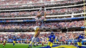 INGLEWOOD, CALIFORNIA - OCTOBER 30: Christian McCaffrey #23 of the San Francisco 49ers catches the ball for a touchdown as Jalen Ramsey #5 and Taylor Rapp #24 of the Los Angeles Rams defend during the third quarter at SoFi Stadium on October 30, 2022 in Inglewood, California. (Photo by Ronald Martinez/Getty Images)