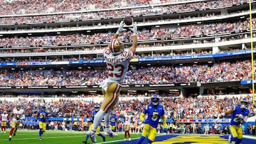 INGLEWOOD, CALIFORNIA - OCTOBER 30: Christian McCaffrey #23 of the San Francisco 49ers catches the ball for a touchdown as Jalen Ramsey #5 and Taylor Rapp #24 of the Los Angeles Rams defend during the third quarter at SoFi Stadium on October 30, 2022 in Inglewood, California. (Photo by Ronald Martinez/Getty Images)