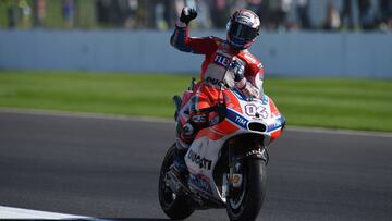 Ducati Team's Italian rider Andrea Dovizioso celebrates first place after the MotoGP race of the British Grand Prix at Silverstone circuit in Northamptonshire, southern England, on August 27, 2017. / AFP PHOTO / Oli SCARFF