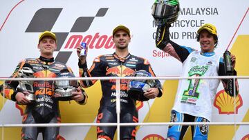 Red Bull KTM Ajo rider Miguel Oliveira of Portugal (C) celebrates his victory with second-placed Red Bull KTM Ajo rider Brad Binder of South Africa (L) and third-placed EG 0,0 Marc VDS rider Franco Morbidelli of Italy (R) in the Moto2 class Malaysia Grand Prix at the Sepang International Circuit in Sepang on October 29, 2017. / AFP PHOTO / MOHD RASFAN