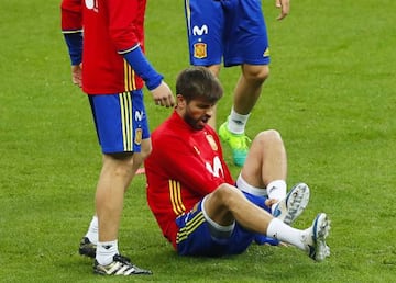 Gerard Piqué grimaces after going down with an ankle knock.