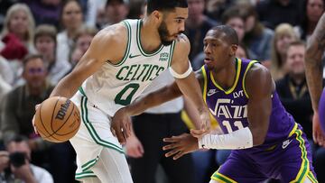 Mar 12, 2024; Salt Lake City, Utah, USA; Boston Celtics forward Jayson Tatum (0) moves the ball as Utah Jazz guard Kris Dunn (11) defends during the third quarter at Delta Center. Mandatory Credit: Rob Gray-USA TODAY Sports