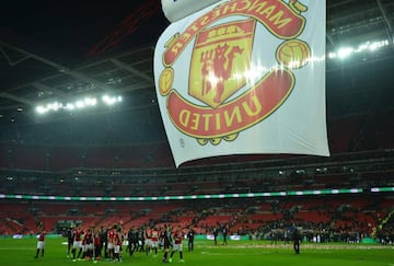 Manchester United's players celebrate on the pitch after their victory in the English League Cup final football match between Manchester United and Southampton at Wembley