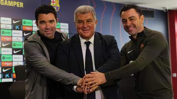 (From L) Barcelona's Sports Director Anderson de Souza "Deco", FC Barcelona President Joan Laporta and Barcelona's Spanish coach Xavi pose for pictures before a press conference at the Joan Gamper training ground in Sant Joan Despi, near Barcelona, on April 25, 2024. Xavi will remain as coach of Barcelona, the Spanish giants told AFP on April 24, despite having announced in January that he planned to quit at the end of the season due to the "cruel and unpleasant" nature of the job. (Photo by LLUIS GENE / AFP)