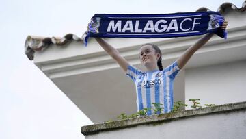 Aficionada del M&aacute;laga sale al balc&oacute;n.