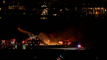 Firefighters work on a burning Japan Airlines' A350 airplane at Haneda International Airport, in Tokyo, Japan January 2, 2024. REUTERS/Issei Kato