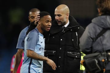 Manchester City manager Pep Guardiola celebrates with Raheem Sterling.