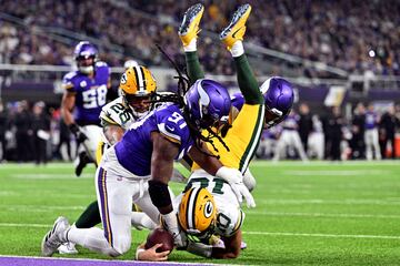 Dec 31, 2023; Minneapolis, Minnesota, USA; Green Bay Packers quarterback Jordan Love (10) scores on a touchdown  run as Minnesota Vikings linebacker Pat Jones II (91) and safety Camryn Bynum (24) defend and running back AJ Dillon (28) looks on during the second quarter at U.S. Bank Stadium. Mandatory Credit: Jeffrey Becker-USA TODAY Sports     TPX IMAGES OF THE DAY