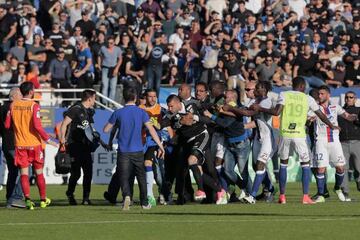 Lyon's goalkeeper Anthony Lopes attacked by Bastia supporters who invaded the pitch at the Armand Cesari stadium.