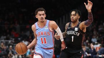 Mar 9, 2019; Atlanta, GA, USA; Atlanta Hawks guard Trae Young (11) drives against Brooklyn Nets guard D'Angelo Russell (1) in the first quarter at State Farm Arena. Mandatory Credit: Jason Getz-USA TODAY Sports