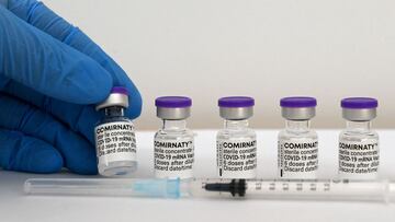 A health worker holds a vial of the Comirnaty vaccine by Pfizer-BioNTech against Covid-19 that can be caused by the novel coronavirus are pictured at the vaccination center in Rosenheim, southern Germany, on April 20, 2021, amid the novel coronavirus / CO