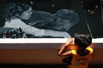 Ashly Muceros, a 10-year-old fan of Kobe Bryant, looks at the mural painted in memory of him and his daughter Gianna, hours after they died in a helicopter crash, on the basketball court of a housing tenement in Taguig City, Metro Manila, Philippines, Jan