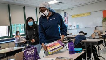 STAMFORD, CONNECTICUT - OCTOBER 27: Abigail Previlon, 13, packs up following her 8th grade language arts class at Scofield Magnet Middle School on October 27, 2020 in Stamford, Connecticut. Previlon is hearing impaired and requires sign language translati